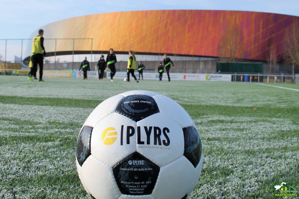 PLYRS match ball on a frosty pitch with a training session in the background