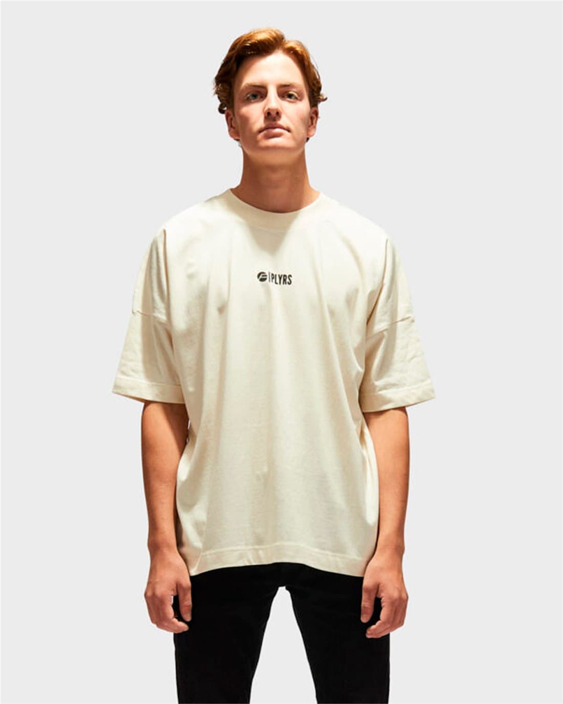 Model wearing an oversized raw-cotton PLYRS T-shirt from the RAW collection